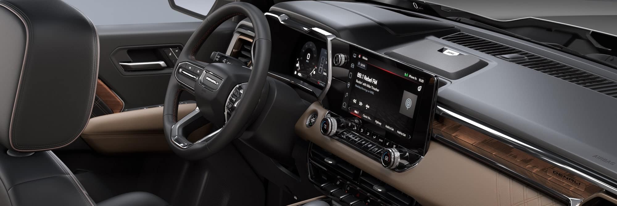 Luxurious car interior featuring a leather steering wheel, touchscreen display, and stylish dashboard design.