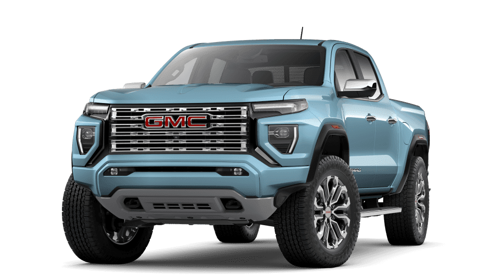 Light blue GMC truck with bold grille and rugged design, showcasing off-road capabilities.