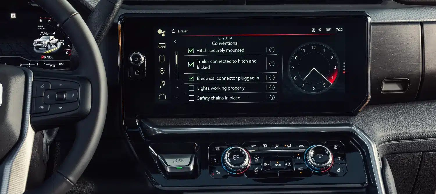 Car dashboard displaying trailer checklist and settings, with steering wheel and digital controls.