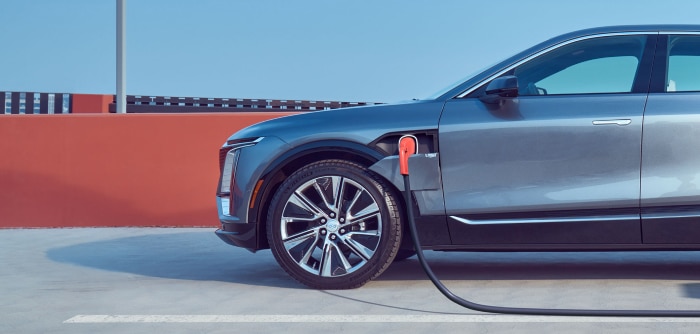 Electric car charging at a station, showcasing modern vehicle design and eco-friendly technology.