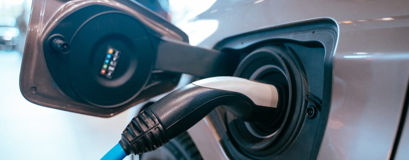 Electric car charging with a plug in a charging port.
