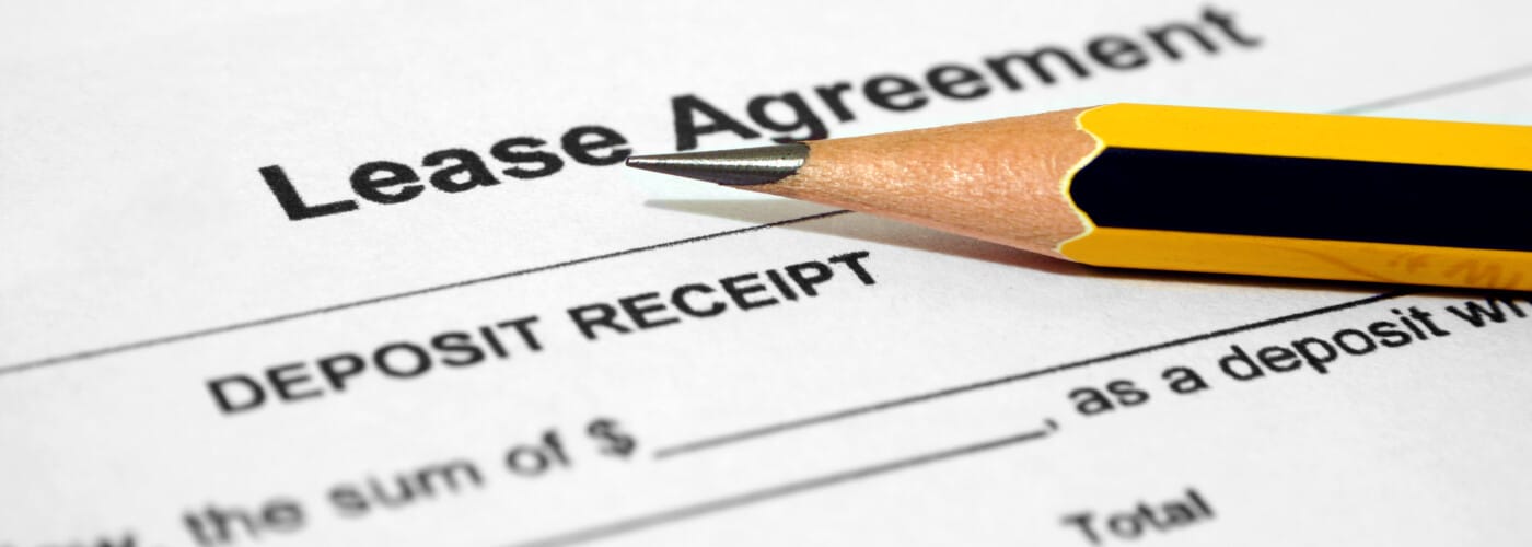 Pencil resting on a lease agreement paper highlighting the deposit receipt section.