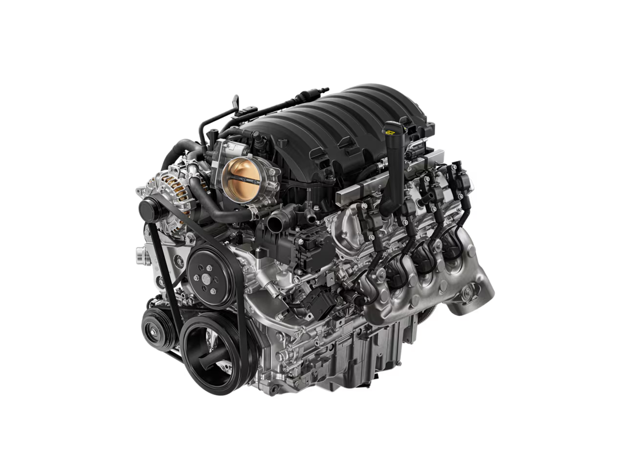 Car engine with visible components, including belts and pistons, showcasing mechanical details.